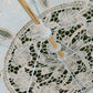 Close-up of lace umbrella spokes and canopy fabric with floral embroidery