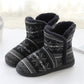 Winter knit slipper boots with dark gray knit upper, white patterned band, and plush lining