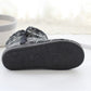 Thick-soled outsole of dark gray winter knit home boots with textured tread pattern