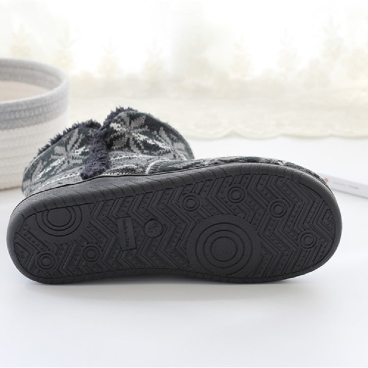 Thick-soled outsole of dark gray winter knit home boots with textured tread pattern