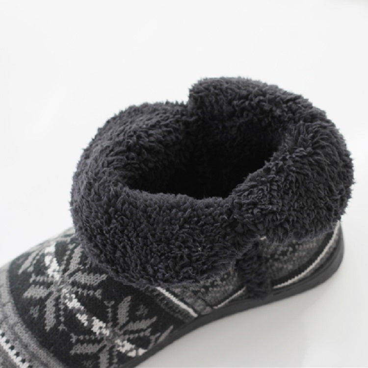 Close-up of dark gray boot opening with plush lining and white patterned knit trim, thick sole