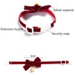 Red velvet adjustable pet collar with bow, snap closure, and gold bell.