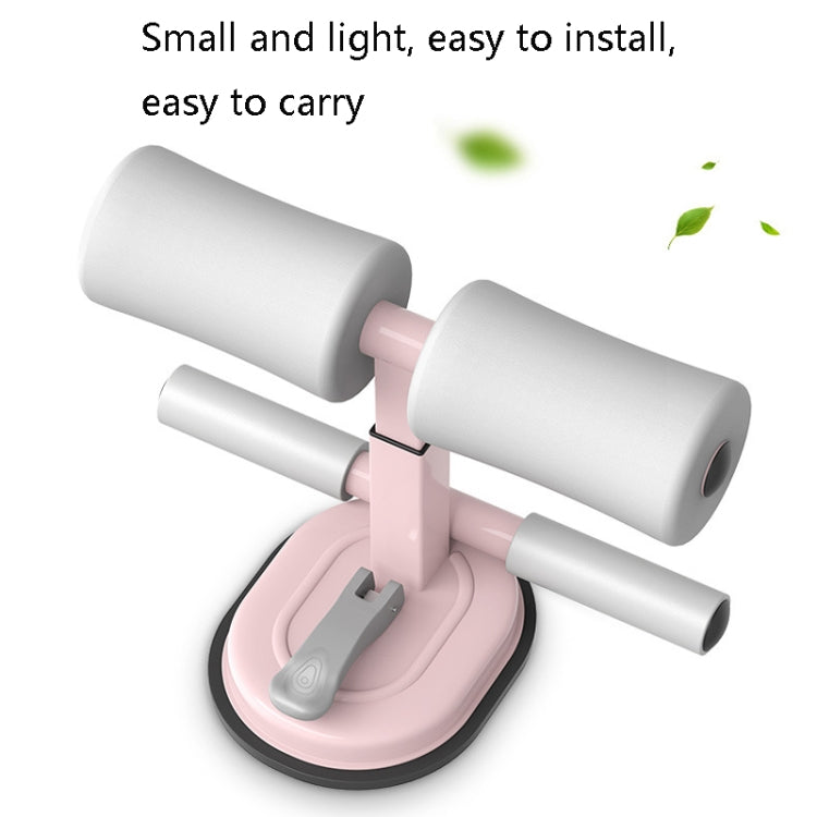 Abdominal crunch assist device with pink base and white foam handles, compact design