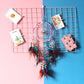 Colorful dream catcher wall hanging with multiple hoops, feathers, and hanging bead charms