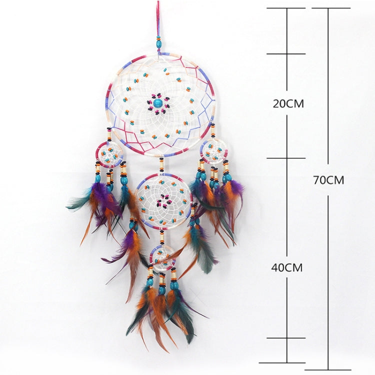 Colorful dream catcher with three woven circles, feather tassels, and bead strands