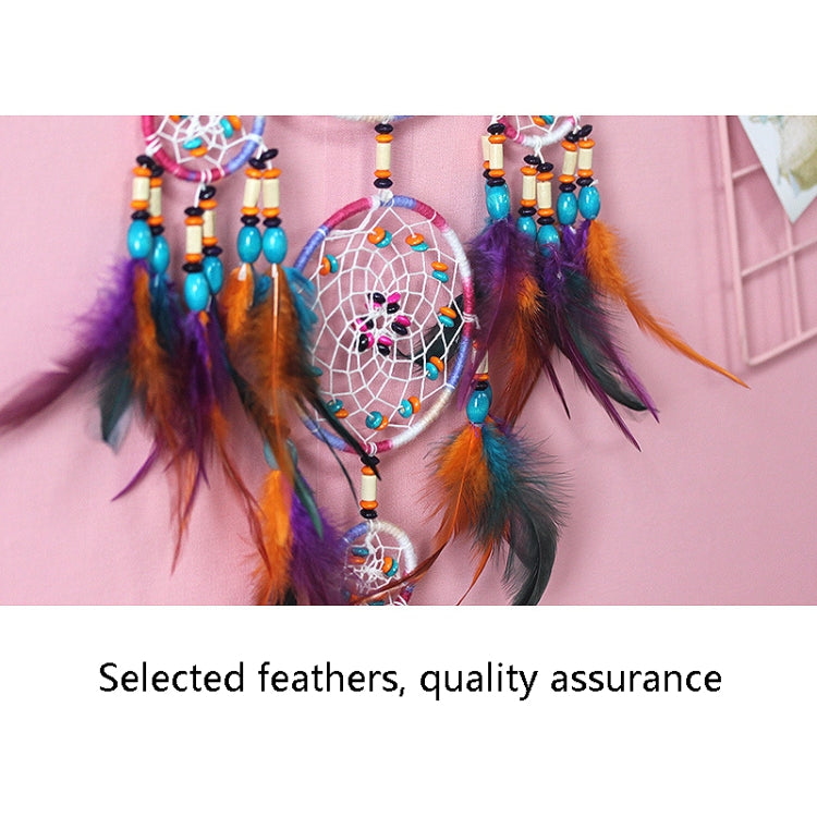 Dream catcher detail with feather tassels and multi-color bead bands