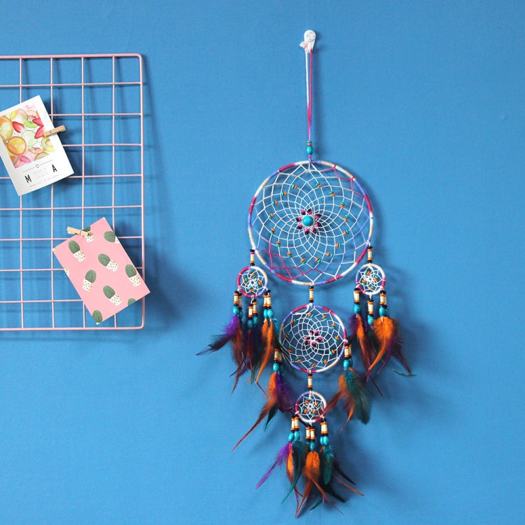 Colorful dream catcher wall hanging with 3 hoops, long feathers, and beaded drops