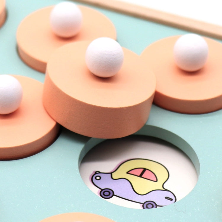 Close-up of wooden memory game tile with white peg and cartoon animal in cutout
