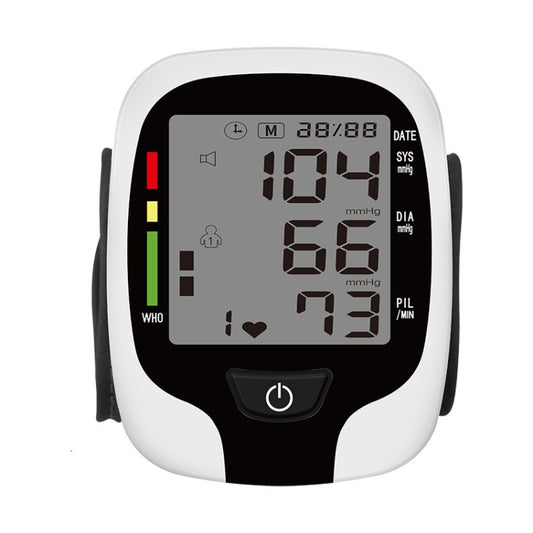 Wrist electronic blood pressure monitor with LCD displaying 104/66, pulse and heart icons