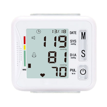 White wrist electronic sphygmomanometer with LCD showing SYS, DIA, and PUL readings.