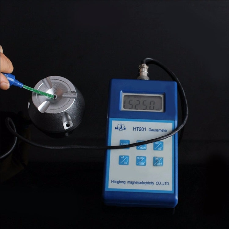 EAS detacher opener shown near a digital gauss meter for magnet strength testing