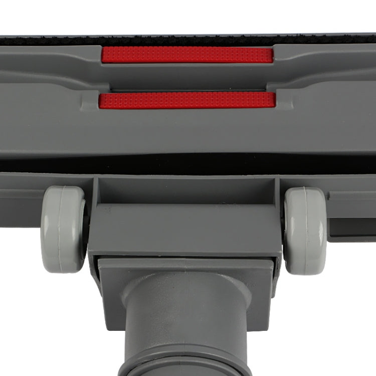 Close-up of gray floor brush head with two red vents and wheel housings