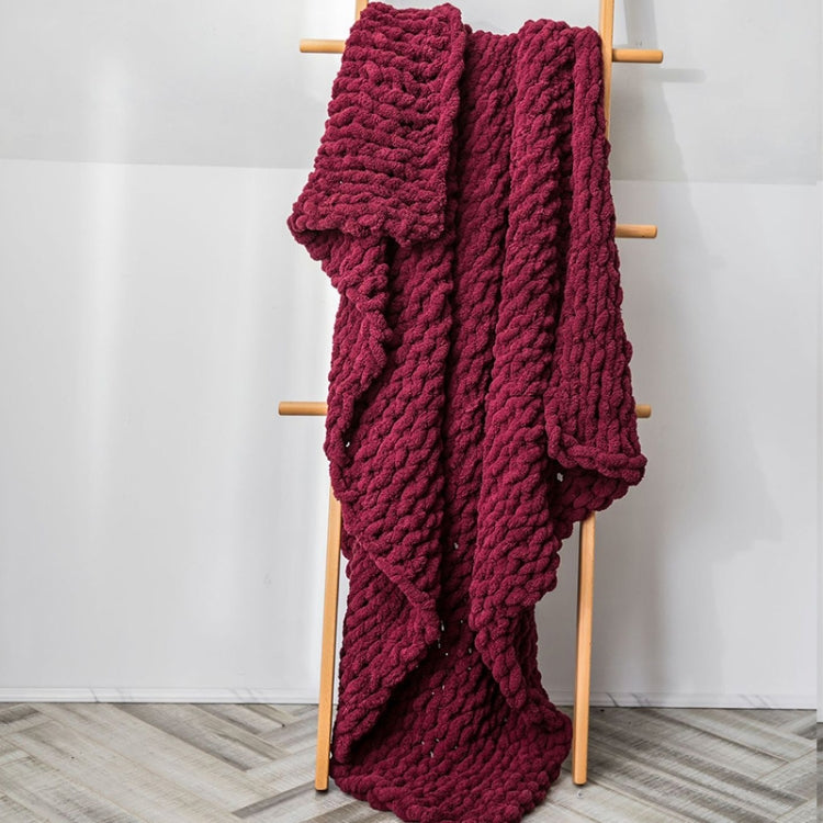Thick knitted wool blanket, wine red, draped over a stand with textured knit
