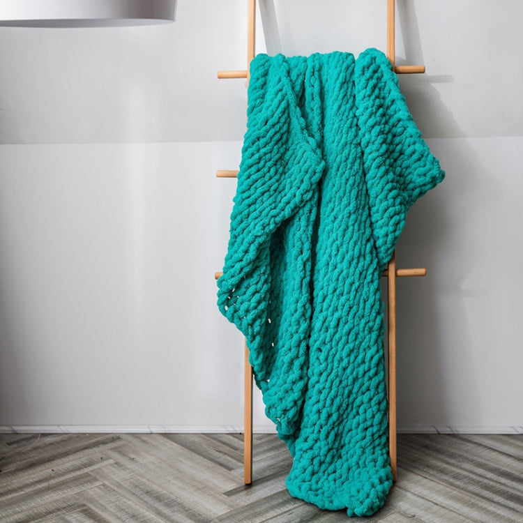 Thick knitted wool blanket, teal, draped over a stand with plush texture