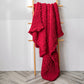 Red chunky cable-knit wool blanket with thick textured weave, draped on a stand