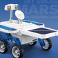 White solar Mars car toy close-up with blue solar panel roof and four rugged wheels.