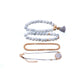 Boho bracelet set with white bead strands, rose-gold chain, and round marble-style charm