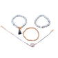 Beaded bracelet set with white marble-style beads, rose-gold accents, tassels, and round charm