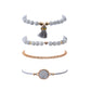 Boho bracelet set with white bead tassel bracelets, rose-gold chain bangle, and heart bead detail