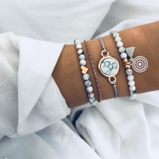 Set of beaded charm bracelets with heart and marble-style beads, tassels, and round pendants