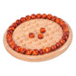 Round wooden chessboard game with orange-red beads and beige dots