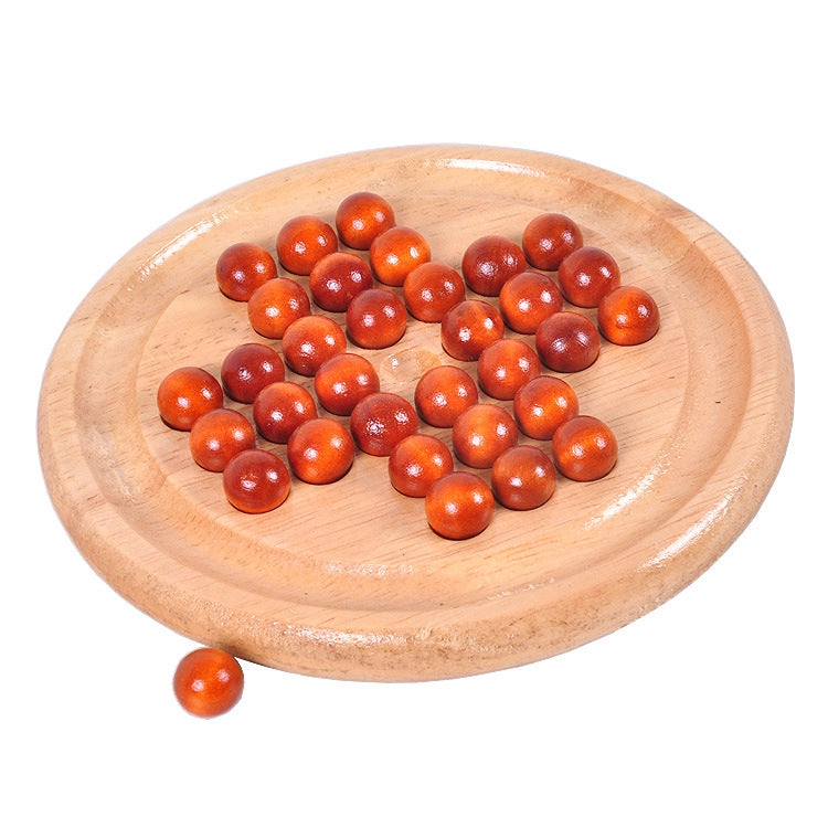 Round wooden chessboard with orange-red wooden balls and one loose piece