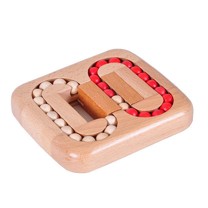 Wood ball maze puzzle with red and white beads in curved tracks