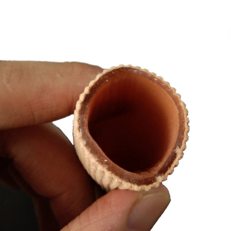 Beige silicone toe separator sleeve with ribbed texture, close-up view