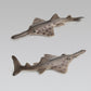 Set of two spotted ray figurines with pointed fins and serrated tail
