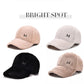 Assorted plush baseball caps with curved brims and M logos in four colors