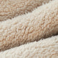 Close-up of plush teddy fleece hood scarf fabric, cream