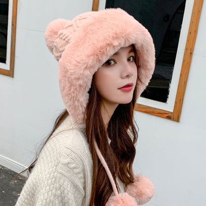 Pink faux-fur trimmed knitted skullcap with pom-pom ties on the sides