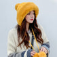 Mustard yellow faux-fur knitted skullcap hat with side pom-pom ball