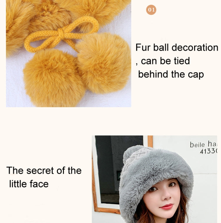 Yellow fuzzy pom-pom decorations tied behind a knit skullcap