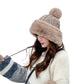 Knit skullcap beanie with faux-fur trim and top pom-pom, beige knit pattern