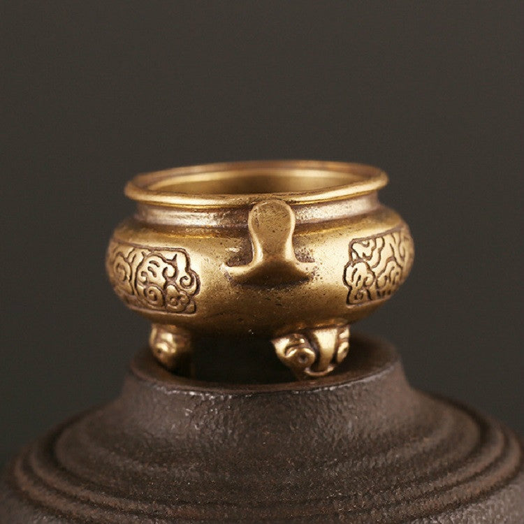 Antique brass censer furnace with ornate sides and wide open top on pedestal base.