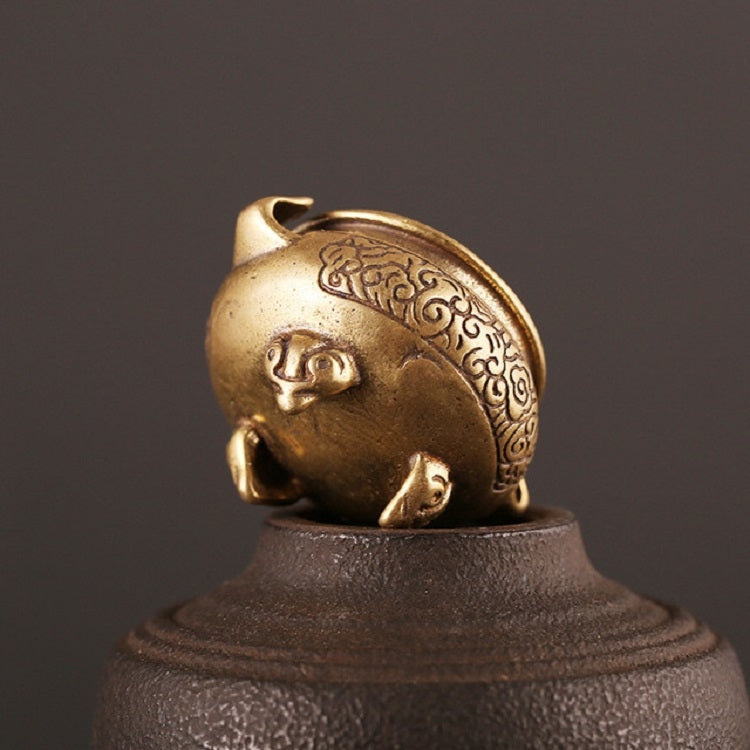 Antique brass censer furnace close-up, face-like ornament and pedestal base texture.