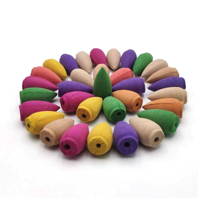 Assorted colored incense sticks with wood-like tips in a pile