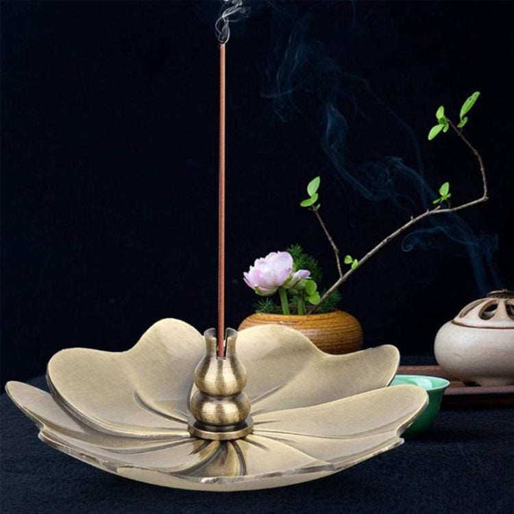 Flower-shaped gold incense burner tray with incense stick and central cone