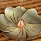 Flower-shaped bronze incense burner with central copper cone on petal tray