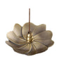 Flower-shaped brass incense burner with central cone and incense stick