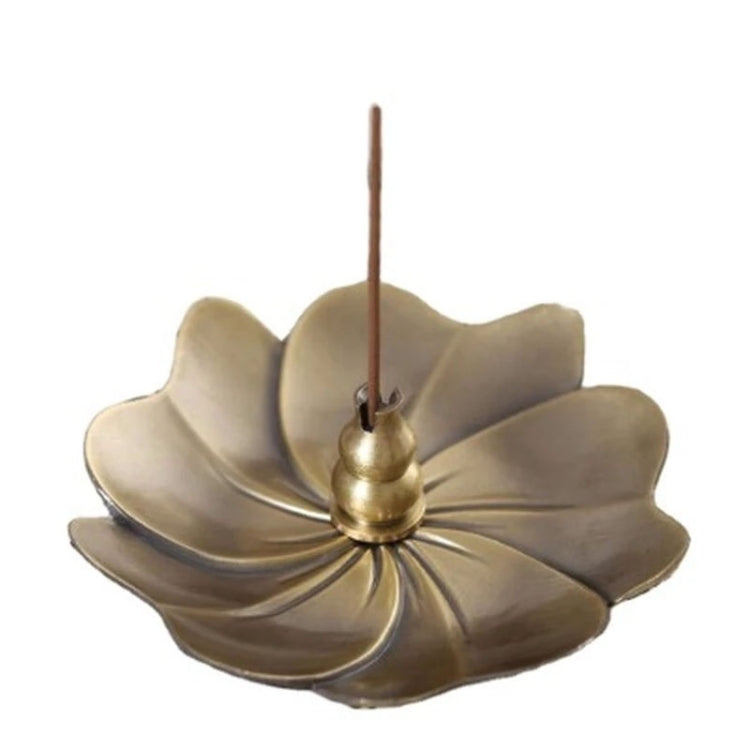 Flower-shaped brass incense burner with central cone and incense stick