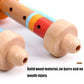 Close-up of wooden horn whistle toy with perforated light wood tube and red-blue bands.