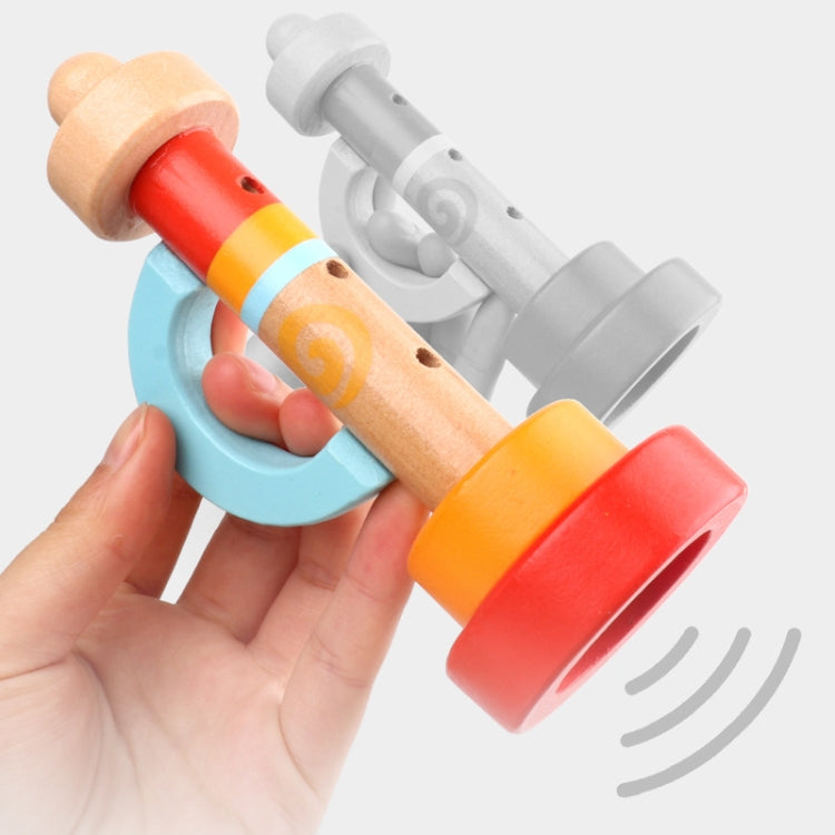 Wooden horn whistle toy in hand; light wood tube with red and orange ring bases.