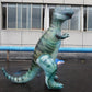 Green inflatable dinosaur water-spray toy standing on ground