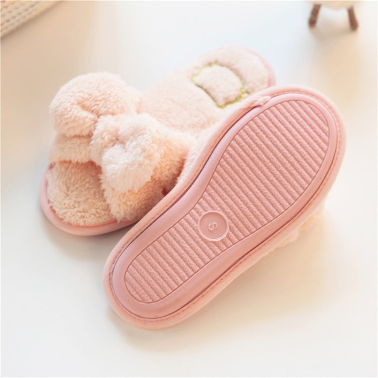 Light pink plush slippers with knotted bow and pink ribbed outsole (sole view)
