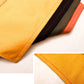 Close-up of orange apron fabric with stitched panels and striped trim