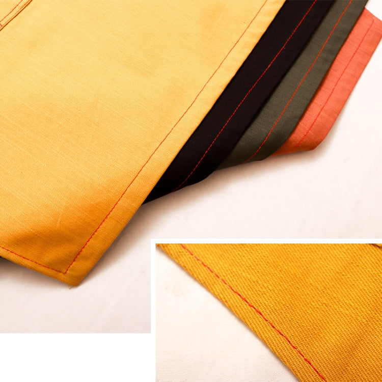 Close-up of orange apron fabric with stitched panels and striped trim