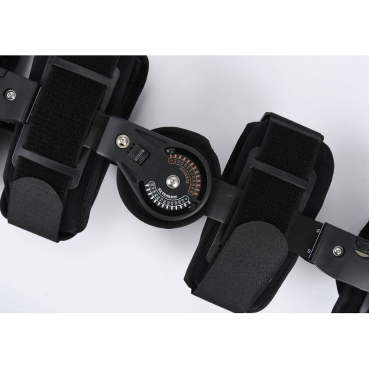 Close-up of black knee brace dial, fabric straps, and metal mounting plates