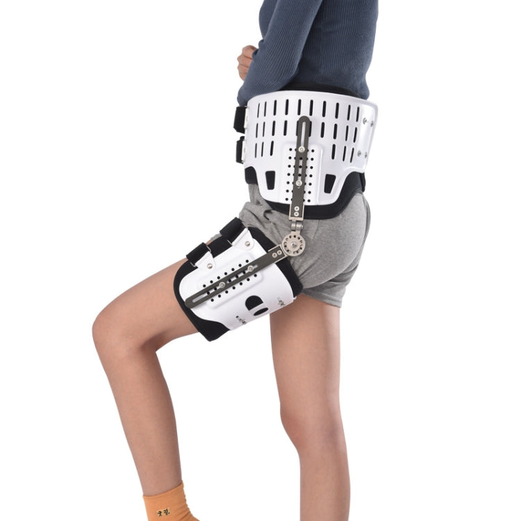 Hip fixation brace with white rigid shell and black straps, worn on leg with gray pants